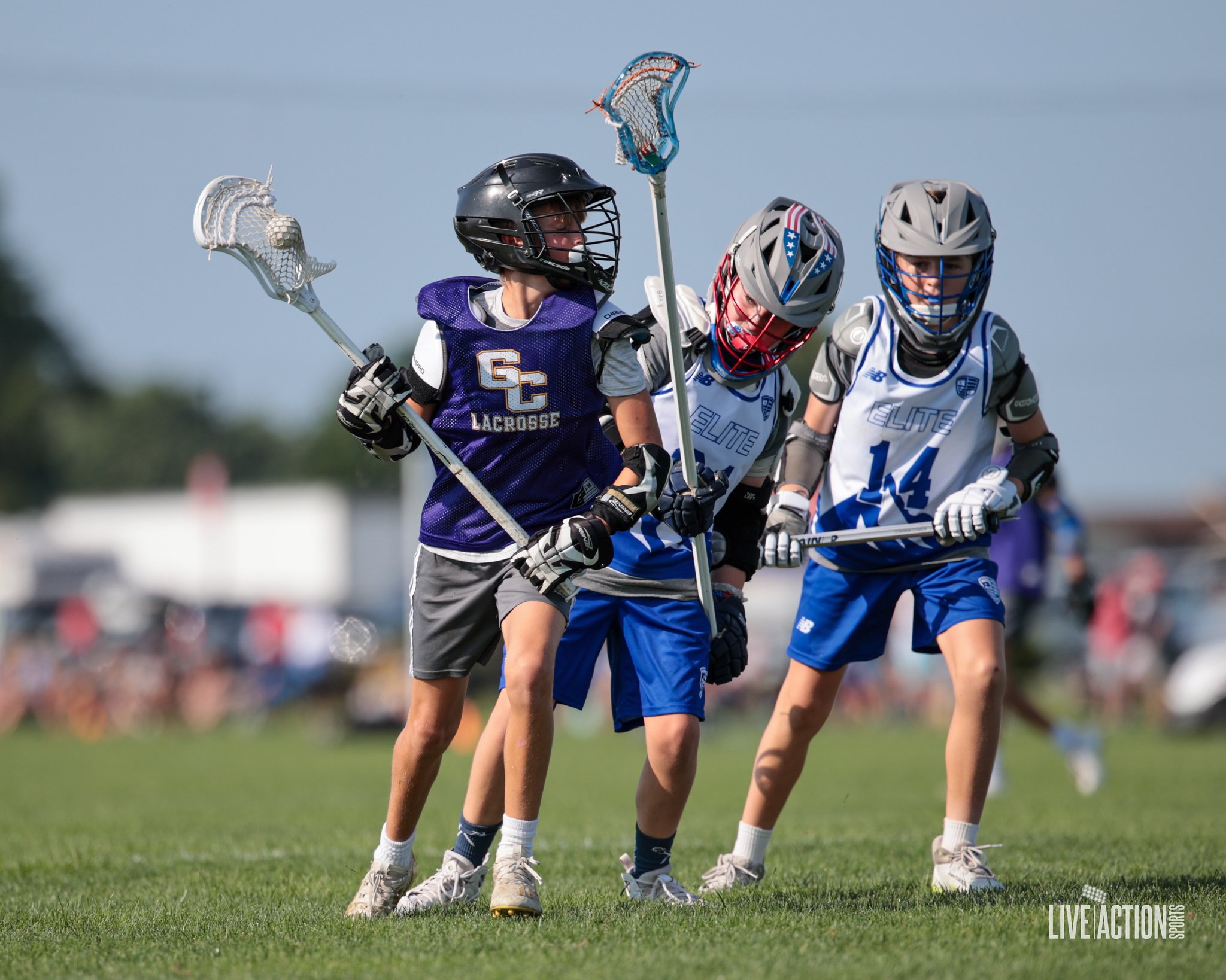 Junior Golden Eagles boys playing lacrosse outdoors on a grassy field